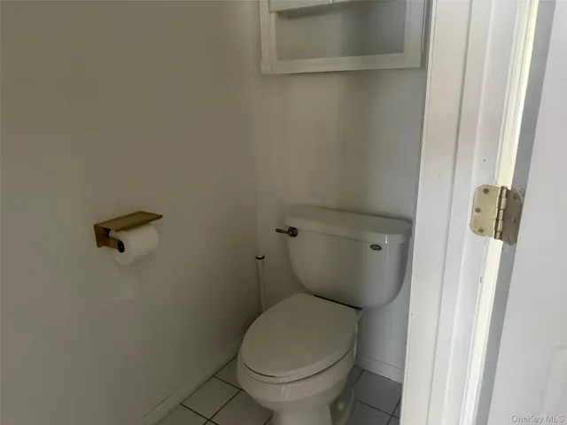 a white toilet sitting next to a shower
