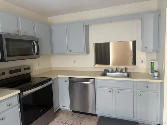 a kitchen with a sink stove and microwave