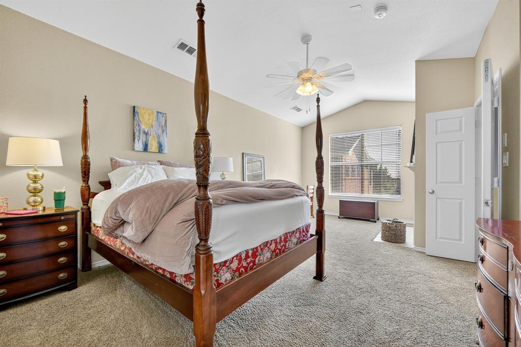 2004 Azure Pointe Richardson, TX 75080 - Photo 13 of 23 a spacious bedroom with a bed and a chandelier