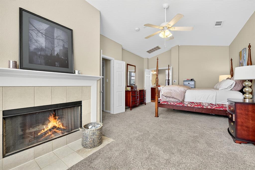 2004 Azure Pointe Richardson, TX 75080 - Photo 14 of 23 a bedroom with a bed and a fireplace