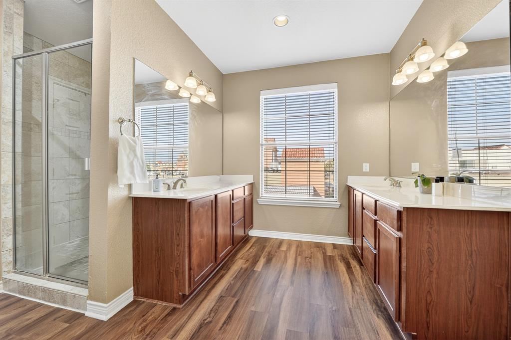 2004 Azure Pointe Richardson, TX 75080 - Photo 18 of 23 a bathroom with a double vanity sink a mirror and a bathtub