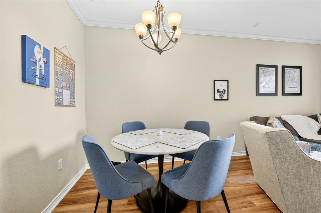 2004 Azure Pointe Richardson, TX 75080 - Photo 7 of 23 a view of a dining room with furniture wooden floor and a chandelier
