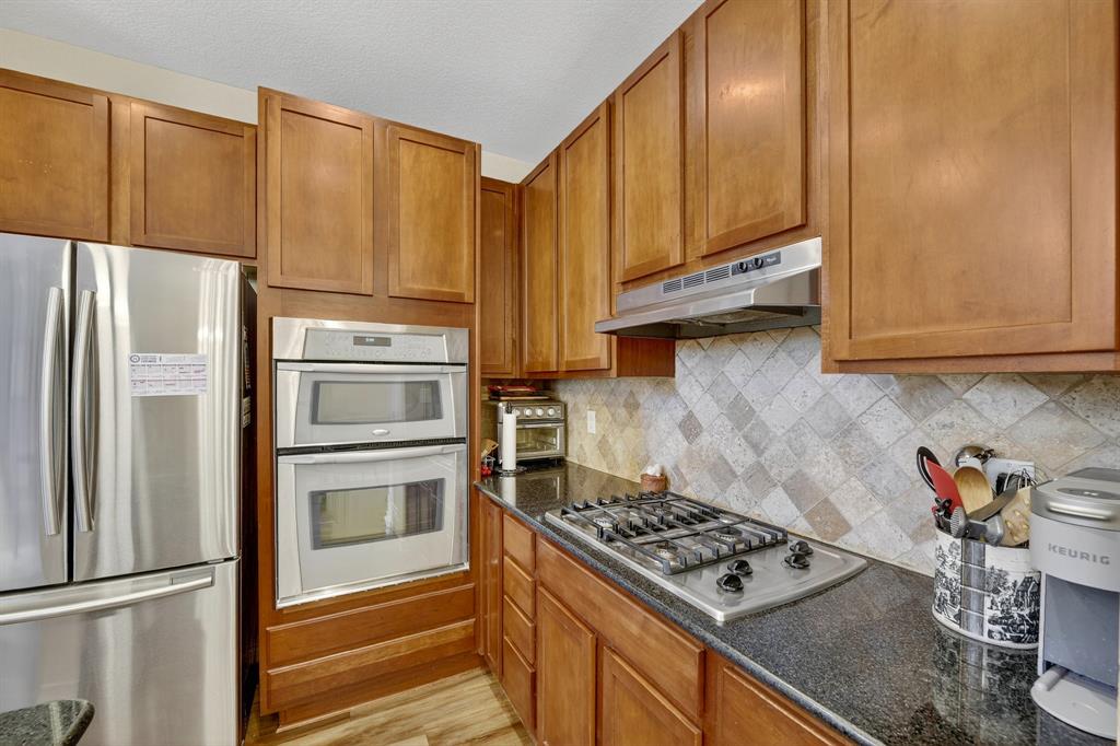 2004 Azure Pointe Richardson, TX 75080 - Photo 8 of 23 a kitchen with stainless steel appliances granite countertop a refrigerator stove and sink