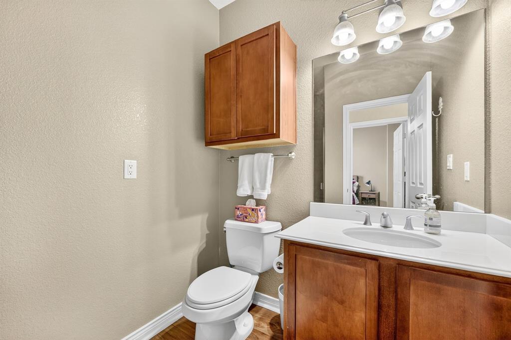 2004 Azure Pointe Richardson, TX 75080 - Photo 9 of 23 a bathroom with a sink vanity mirror and toilet