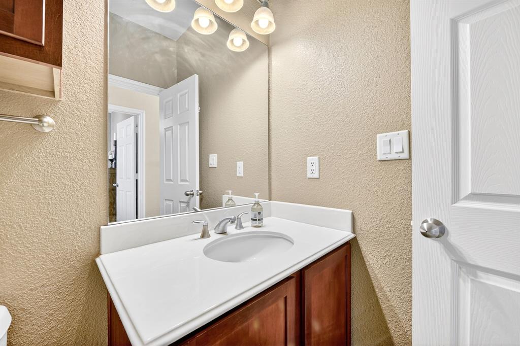 2004 Azure Pointe Richardson, TX 75080 - Photo 10 of 23 a bathroom with a sink vanity and a mirror