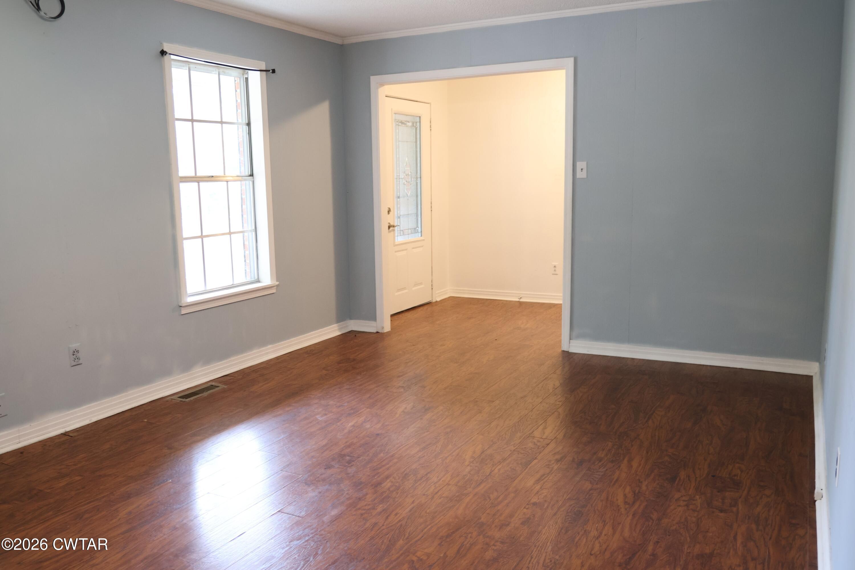 513 Viar Road Dyersburg, TN 38024 - Photo 6 of 37 an empty room with wooden floor and windows