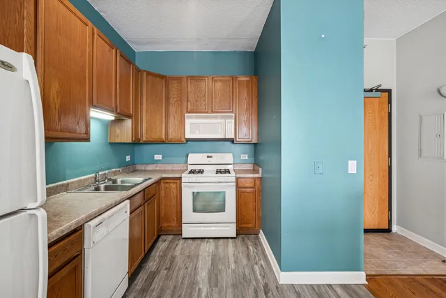 a kitchen with a stove top oven sink and cabinets