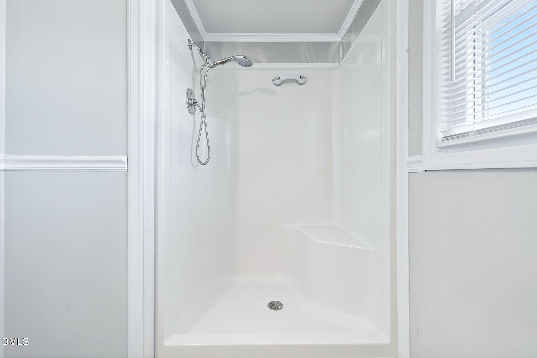 144 Pearidge Road Willow Spring, NC 27592 - Photo 12 of 26 a bathroom with a glass shower door