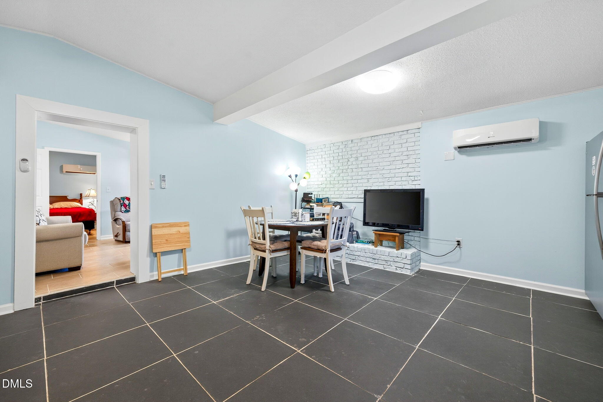 144 Pearidge Road Willow Spring, NC 27592 - Photo 19 of 26 a living room with furniture a flat screen tv and a dining table