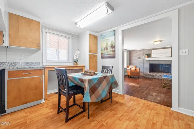 a view of a a dining room with furniture window and wooden floor