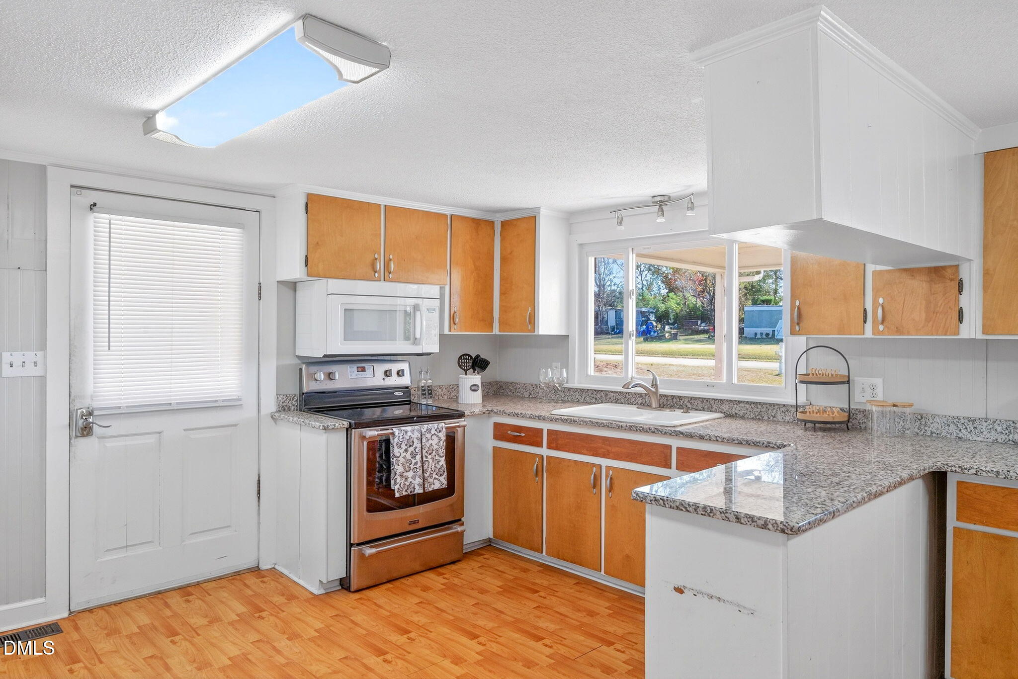 144 Pearidge Road Willow Spring, NC 27592 - Photo 6 of 26 a kitchen with stainless steel appliances granite countertop a sink stove and refrigerator