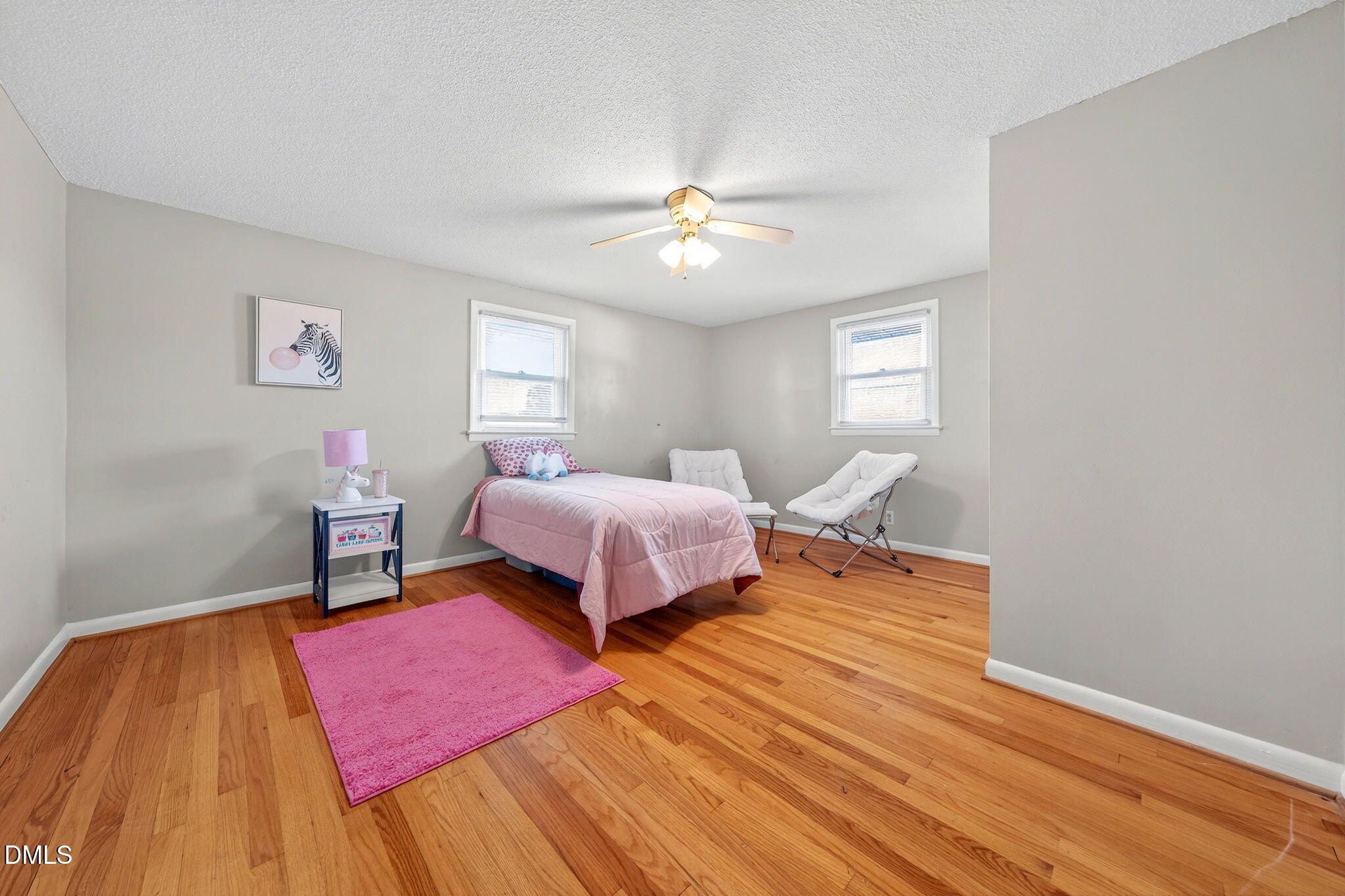 144 Pearidge Road Willow Spring, NC 27592 - Photo 9 of 26 a bedroom with a bed and a chandelier