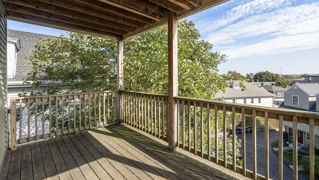 a view of a balcony with wooden floor