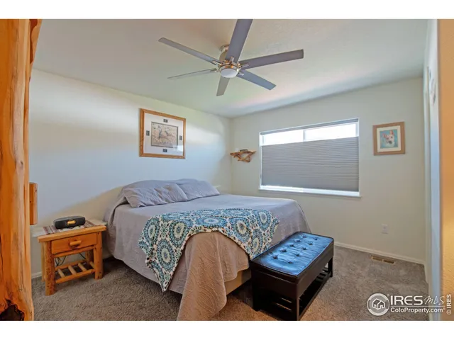 a bedroom with a bed window and a wall