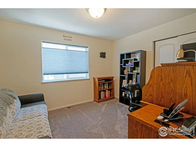 a bedroom with furniture and a book shelf