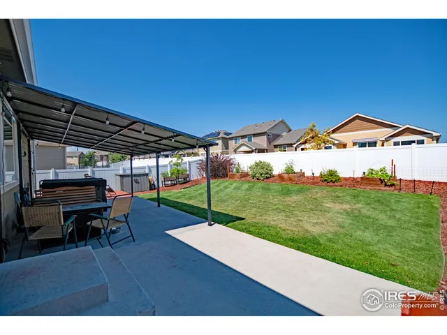 a view of a backyard with sitting area