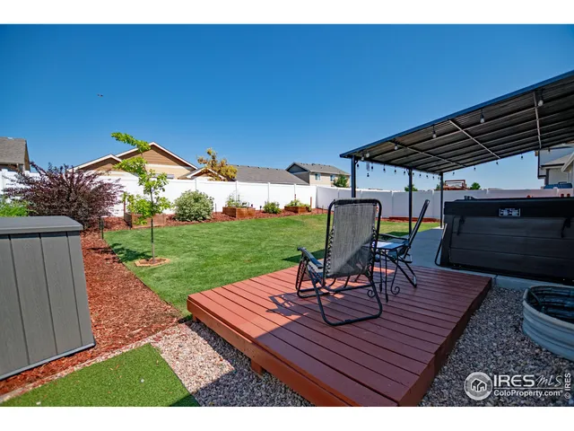 a view of a table and chairs in patio with wooden fence