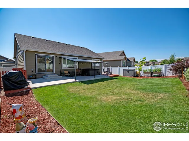 a view of a house with a backyard porch and sitting area