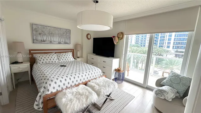 a bedroom with furniture and a large window