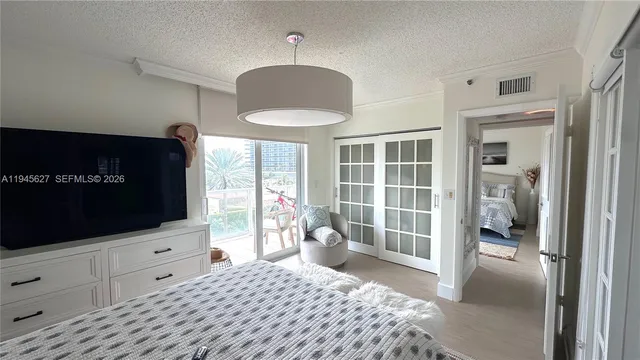 a bedroom with furniture and flat screen tv