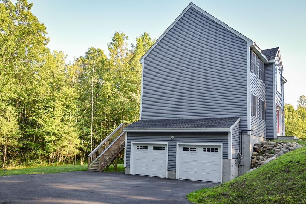 166 Fitchburg Road Townsend, MA 01469 - Photo 26 of 28 a view of a house with a wooden fence