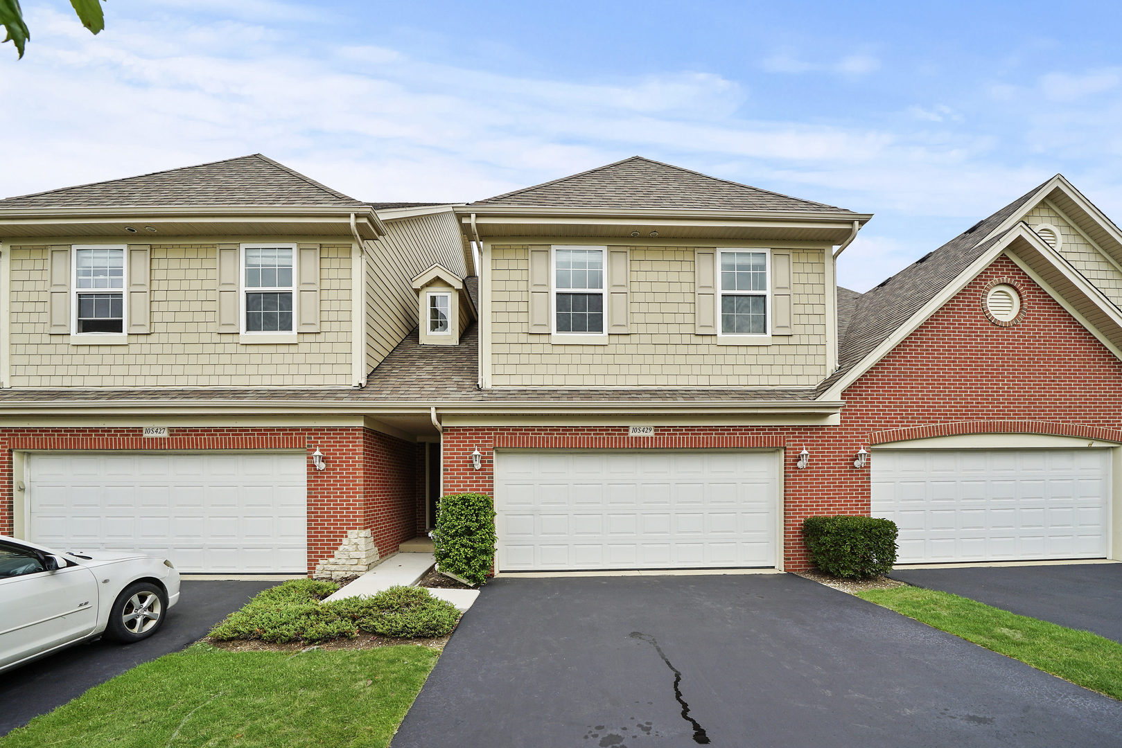 a front view of a house with a yard and garage