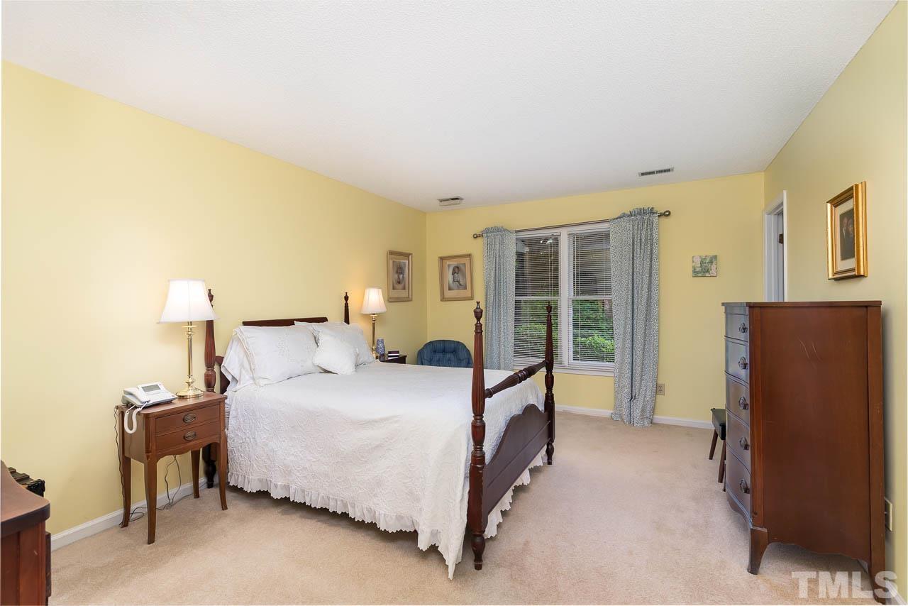 2715 Cottage Circle Raleigh, NC 27613 - Photo 18 of 26 a bedroom with a bed window and a dresser
