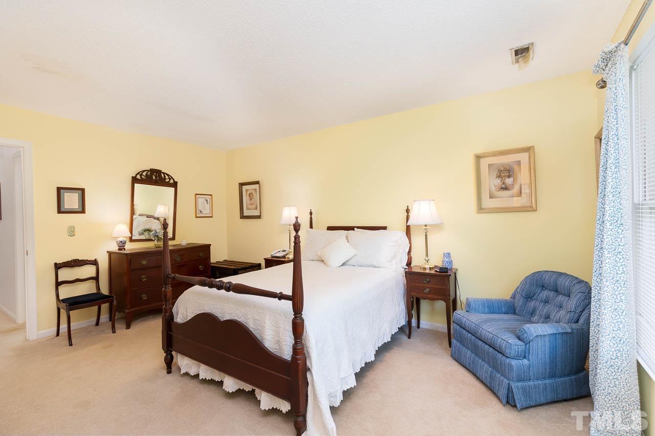 2715 Cottage Circle Raleigh, NC 27613 - Photo 19 of 26 a bedroom with a bed couch and dresser