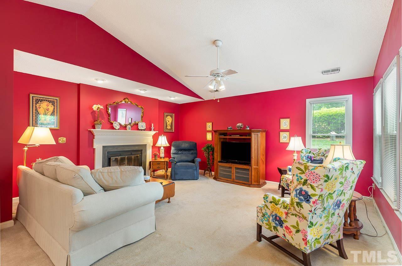 2715 Cottage Circle Raleigh, NC 27613 - Photo 7 of 26 a living room with furniture a fireplace and a flat screen tv