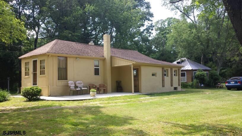 664 Upper Neck Road Elmer, NJ 08318 - Photo 1 of 1 a front view of a house with garden