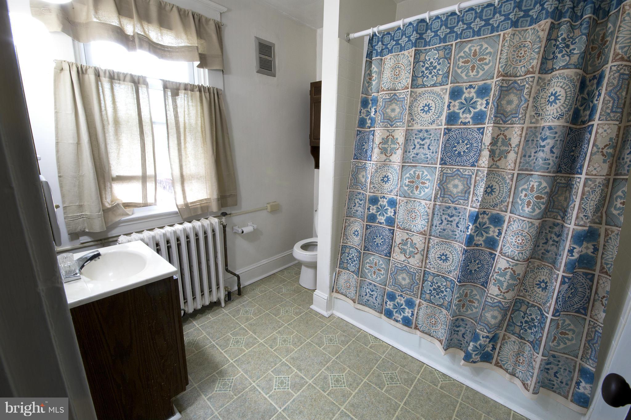 4502 Ridge Avenue Halethorpe, MD 21227 - Photo 14 of 24 a bedroom with a bed and a chair