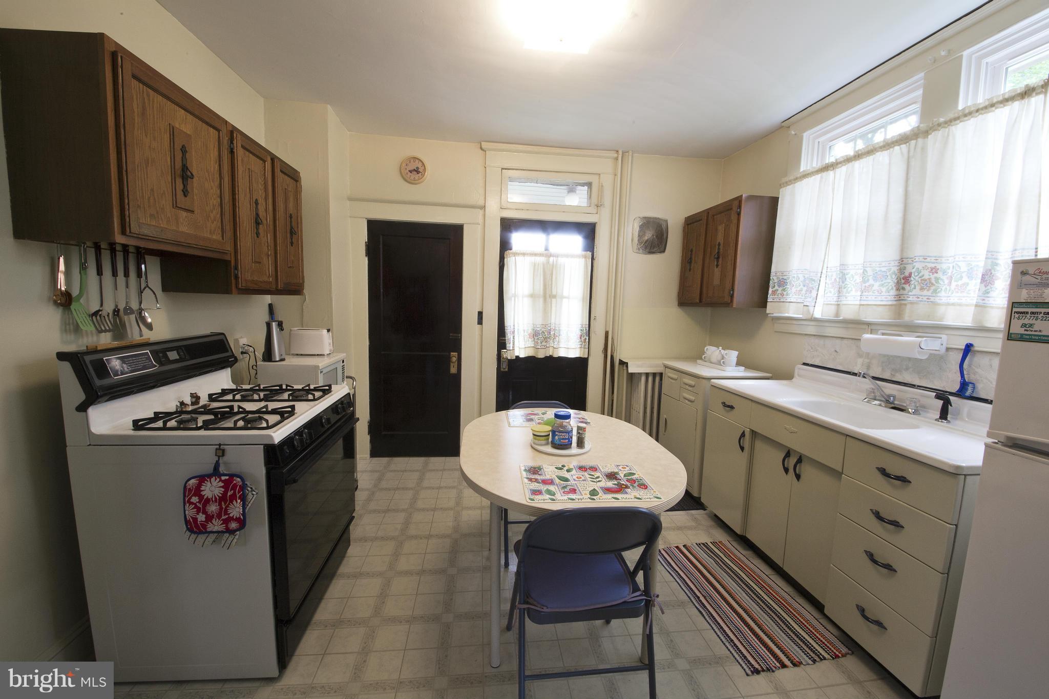 4502 Ridge Avenue Halethorpe, MD 21227 - Photo 5 of 24 a kitchen with a sink stove and refrigerator