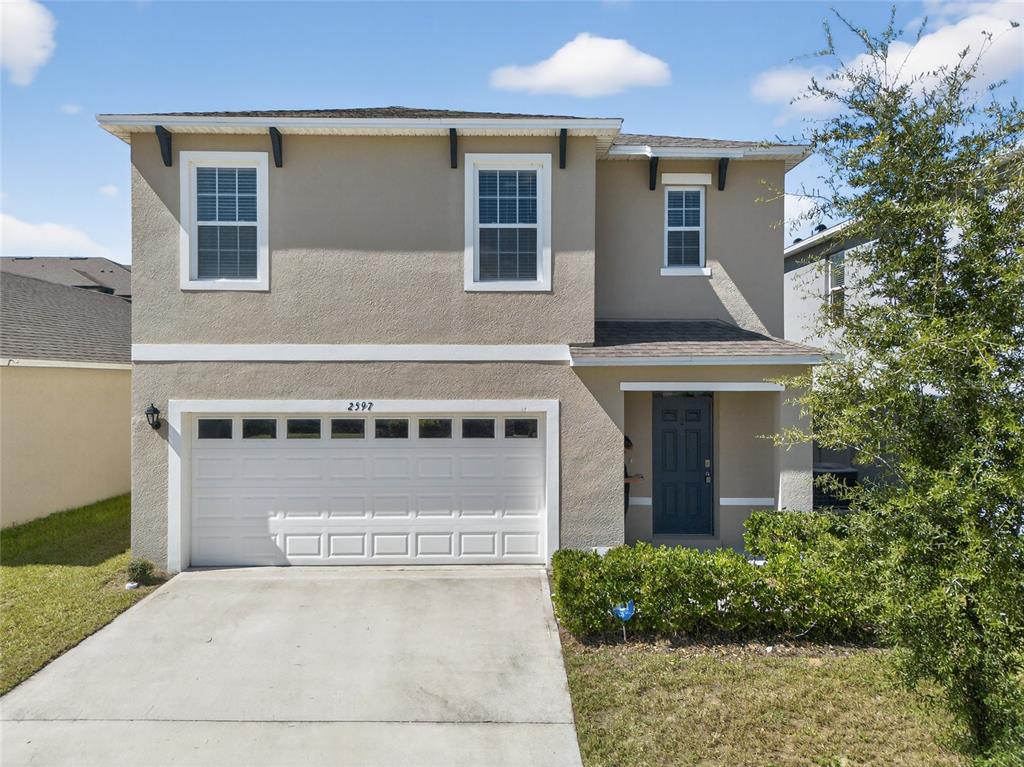2597 Shamrock Street Tavares, FL 32778 - Photo 1 of 57 front view of a house with a yard