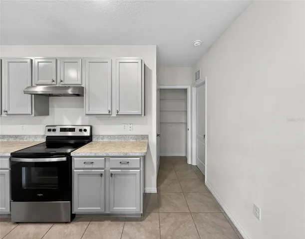 a kitchen with stainless steel appliances granite countertop a stove and a refrigerator