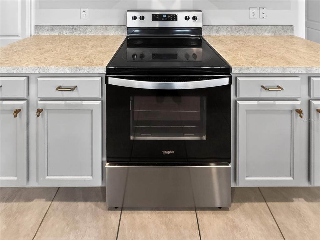 2597 Shamrock Street Tavares, FL 32778 - Photo 12 of 57 a stove top oven sitting inside of a kitchen