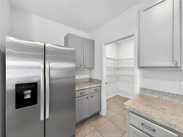 a kitchen with a refrigerator sink and cabinets