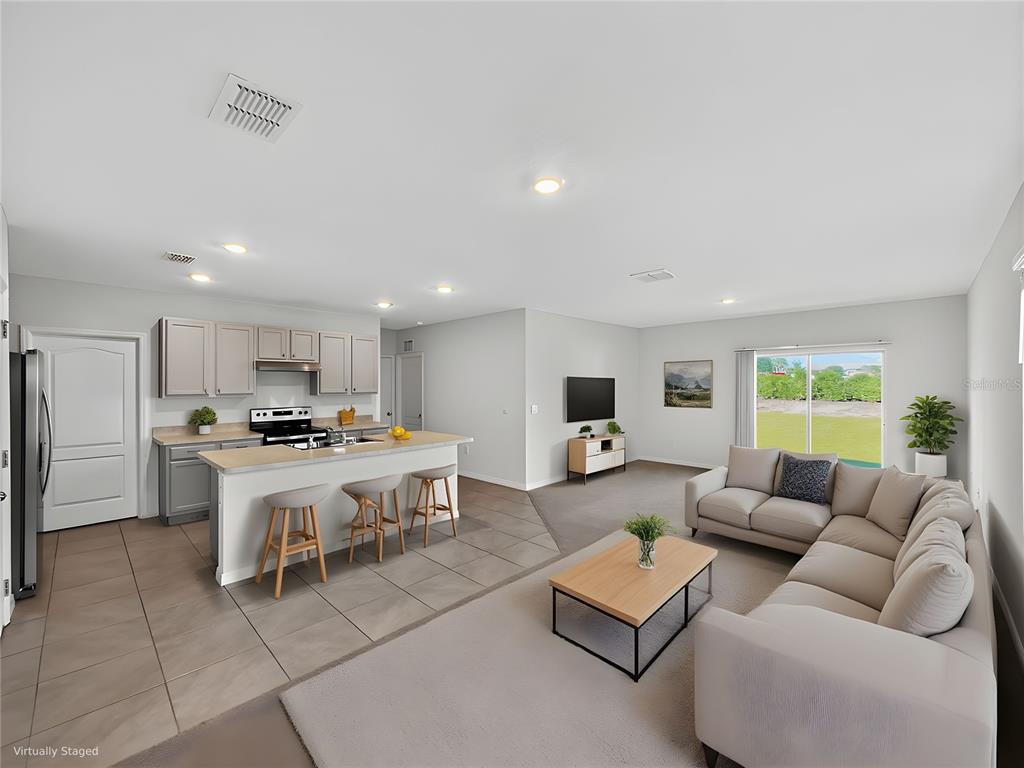 2597 Shamrock Street Tavares, FL 32778 - Photo 19 of 57 a living room with furniture kitchen and a table