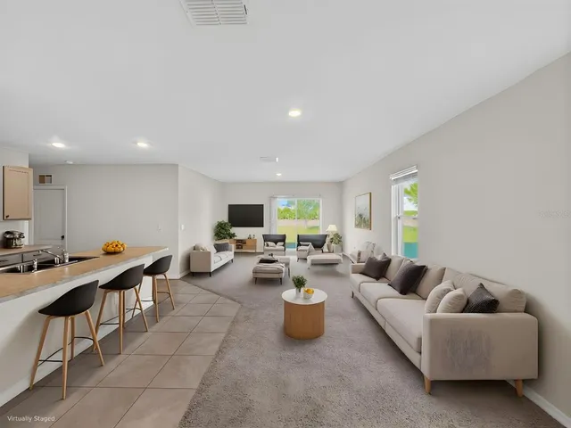 a living room with furniture a window and a table