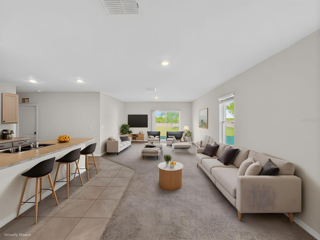 2597 Shamrock Street Tavares, FL 32778 - Photo 2 of 57 a living room with furniture a window and a table