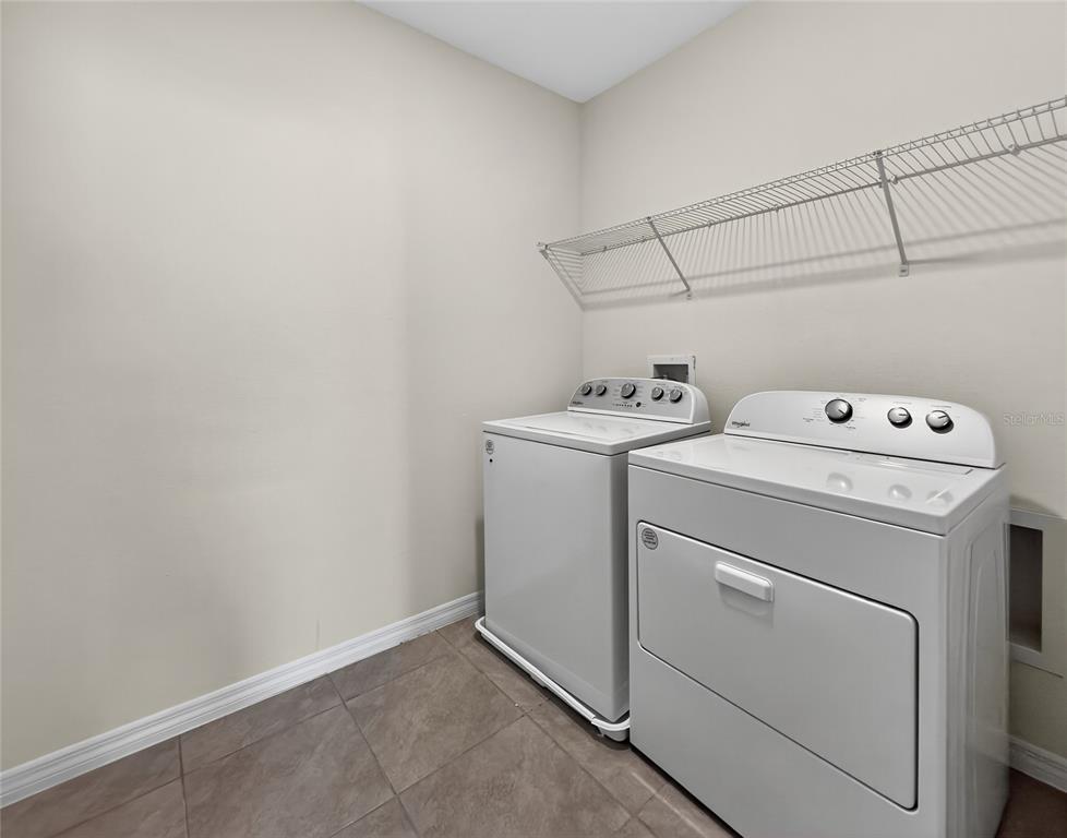2597 Shamrock Street Tavares, FL 32778 - Photo 25 of 57 a utility room with dryer and washer