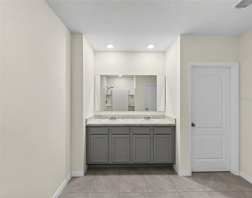 2597 Shamrock Street Tavares, FL 32778 - Photo 30 of 57 a bathroom with a sink and a mirror