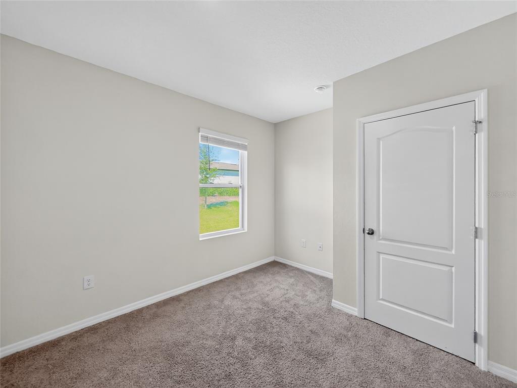 2597 Shamrock Street Tavares, FL 32778 - Photo 34 of 57 a view of an empty room with a window