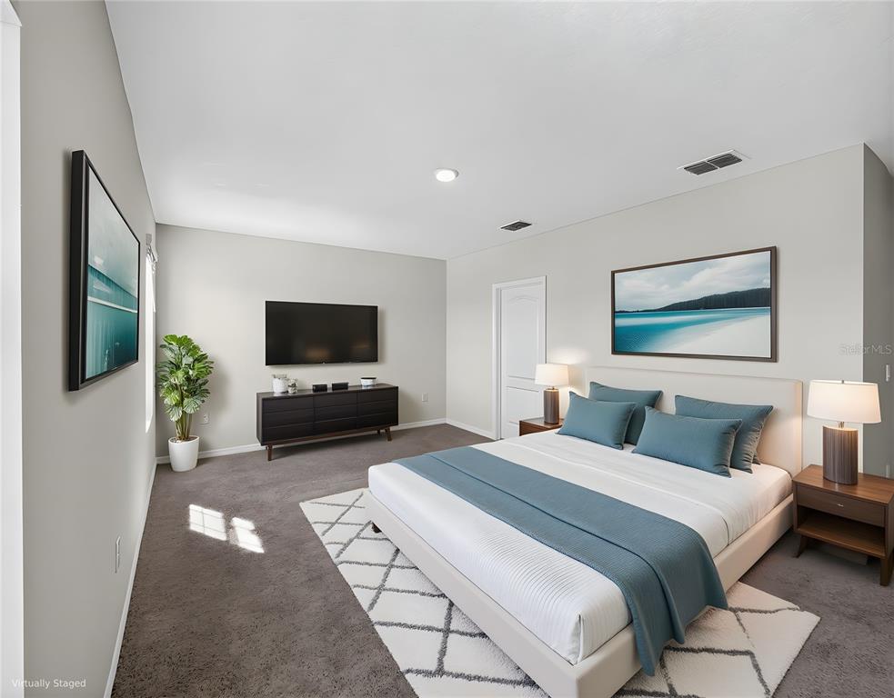 2597 Shamrock Street Tavares, FL 32778 - Photo 46 of 57 a bedroom with a bed and a flat screen tv