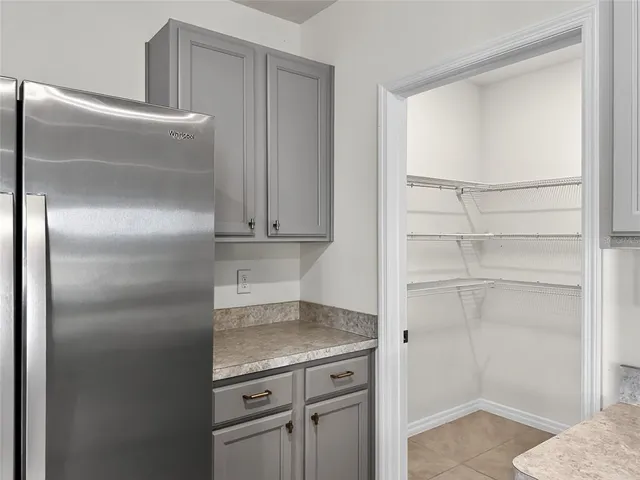 a kitchen with a refrigerator and cabinets