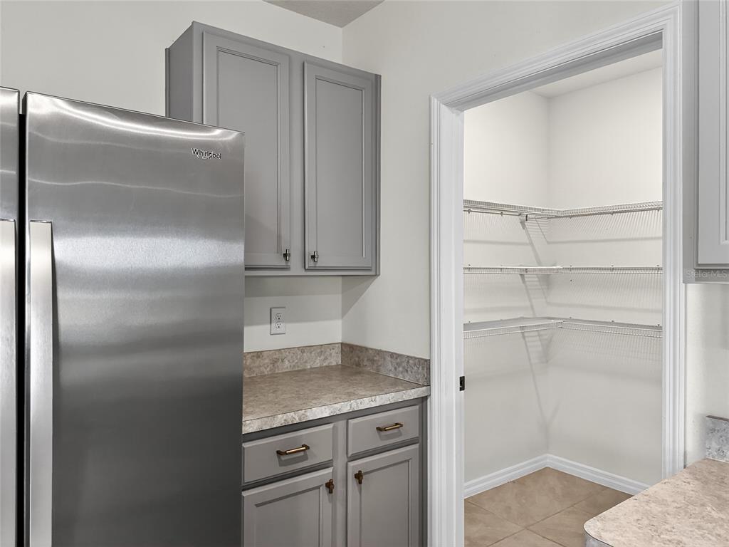 2597 Shamrock Street Tavares, FL 32778 - Photo 6 of 57 a kitchen with a refrigerator and cabinets