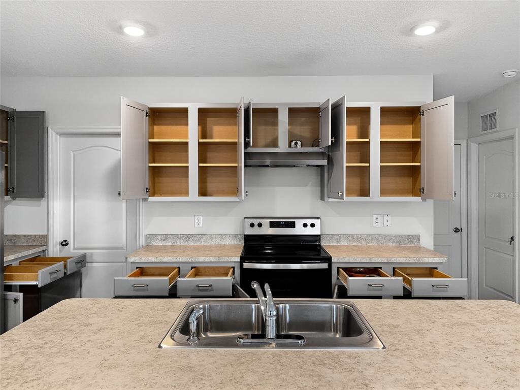 2597 Shamrock Street Tavares, FL 32778 - Photo 8 of 57 a kitchen that has a sink and a stove in it