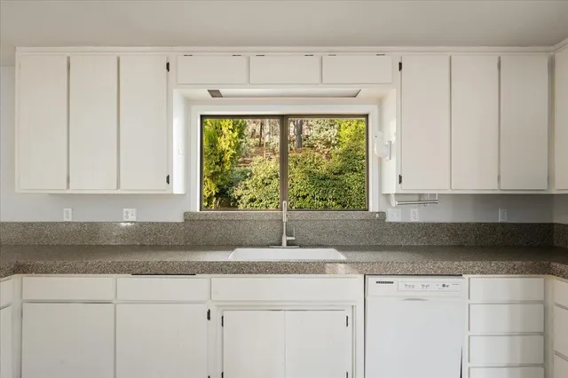 a view of a livingroom with wooden floor and a flat screen tv