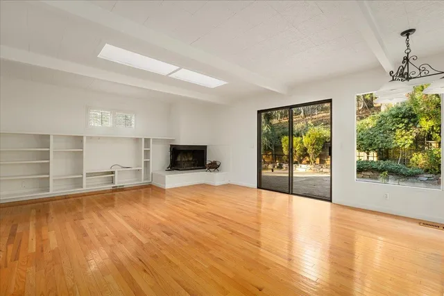 a view of kitchen with refrigerator and wooden floor