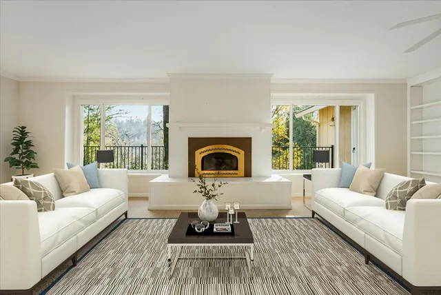 a view of an empty room with a fireplace and a window