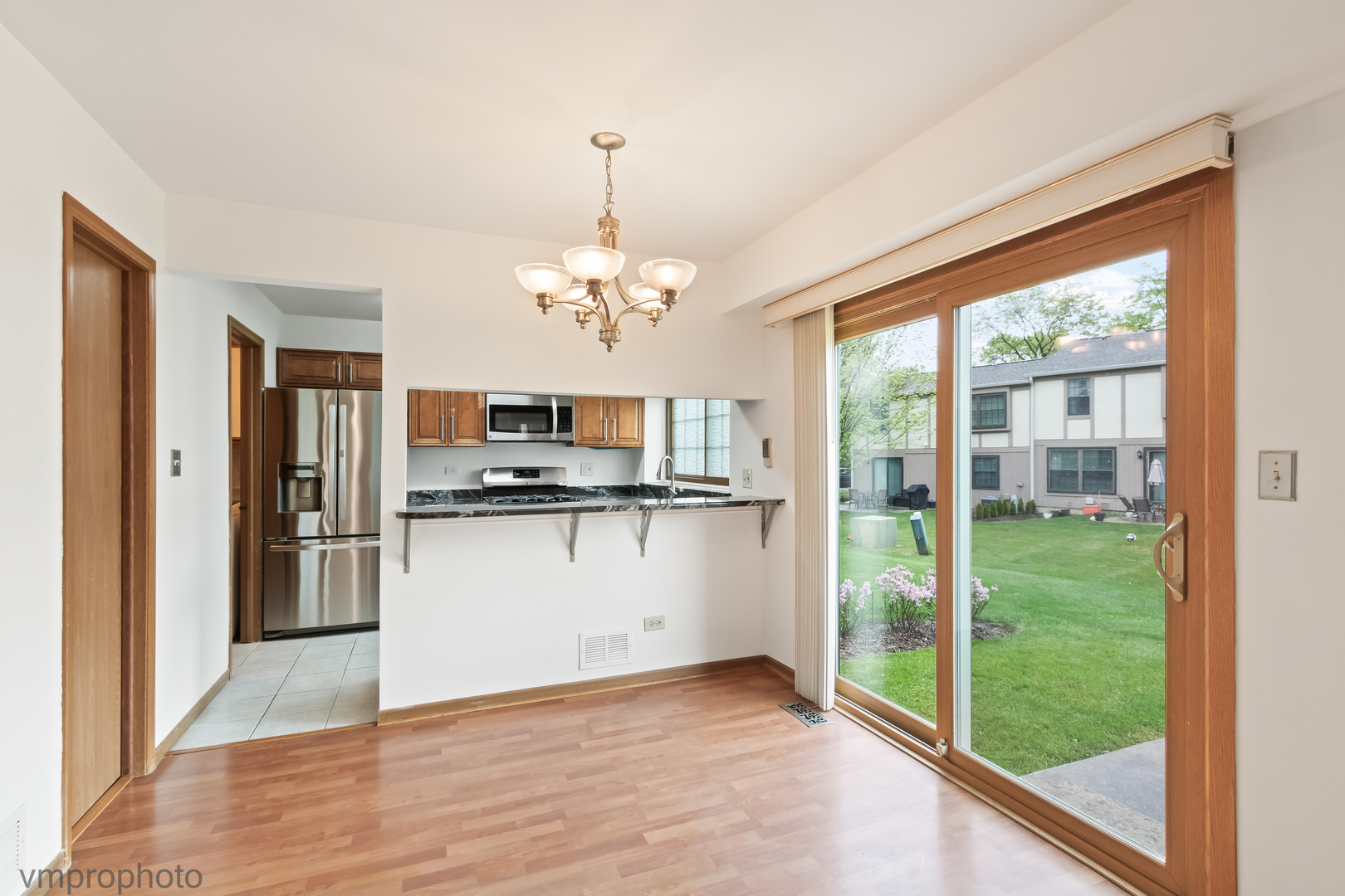 4549 Topaz Drive Hoffman Estates, IL 60192 - Photo 5 of 20 a kitchen with stainless steel appliances granite countertop a refrigerator and a view of living room